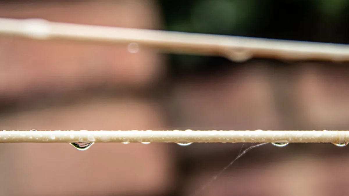 Pressure-compensating button emitter inserted into half inch drip tubing in a garden bed