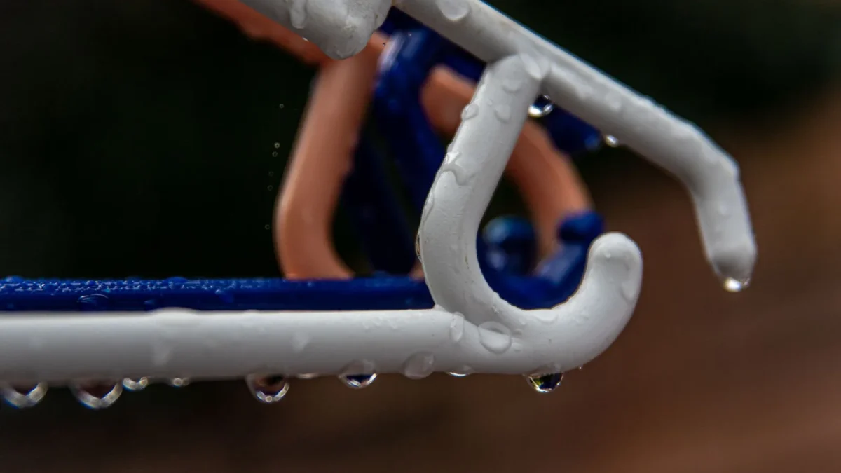 Drip emitter delivering water to the base of a tomato plant through half inch tubing